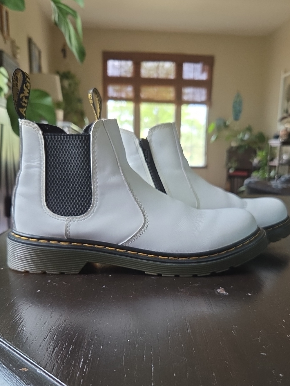 These are Dr. Martens Youth 2976 Chelsea Boots, featuring white leather